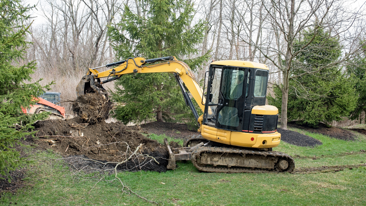 A bulldozer digging through a pile of dirt