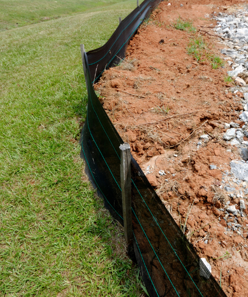 A section of a fence that has been dug in the ground